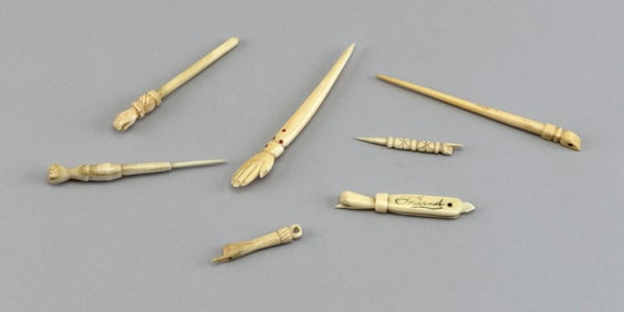 SEVEN BONE SEWING IMPLEMENTS WITH CLENCHED FIST CARVINGS 19th Century Lengths from 2" to 4".