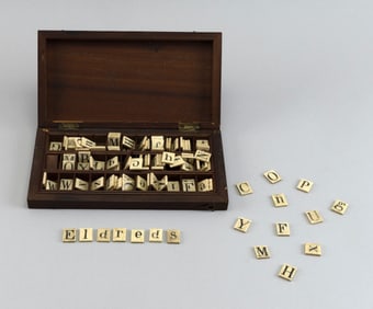 CASED SET OF ENGRAVED BONE ALPHABET TILES Late 19th Century Case height 1.25". Width 9". Depth 5".