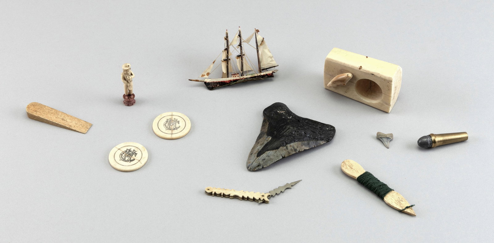 TEN MARITIME ITEMS, MOSTLY WHALEBONE 19th Century Lengths from 1.75" to 4.5".: TEN MARITIME ITEMS, MOSTLY WHALEBONE 19th Century A small ship model, poker chips, a shark's tooth, etc. Lengths from 1.75" to 4.5".