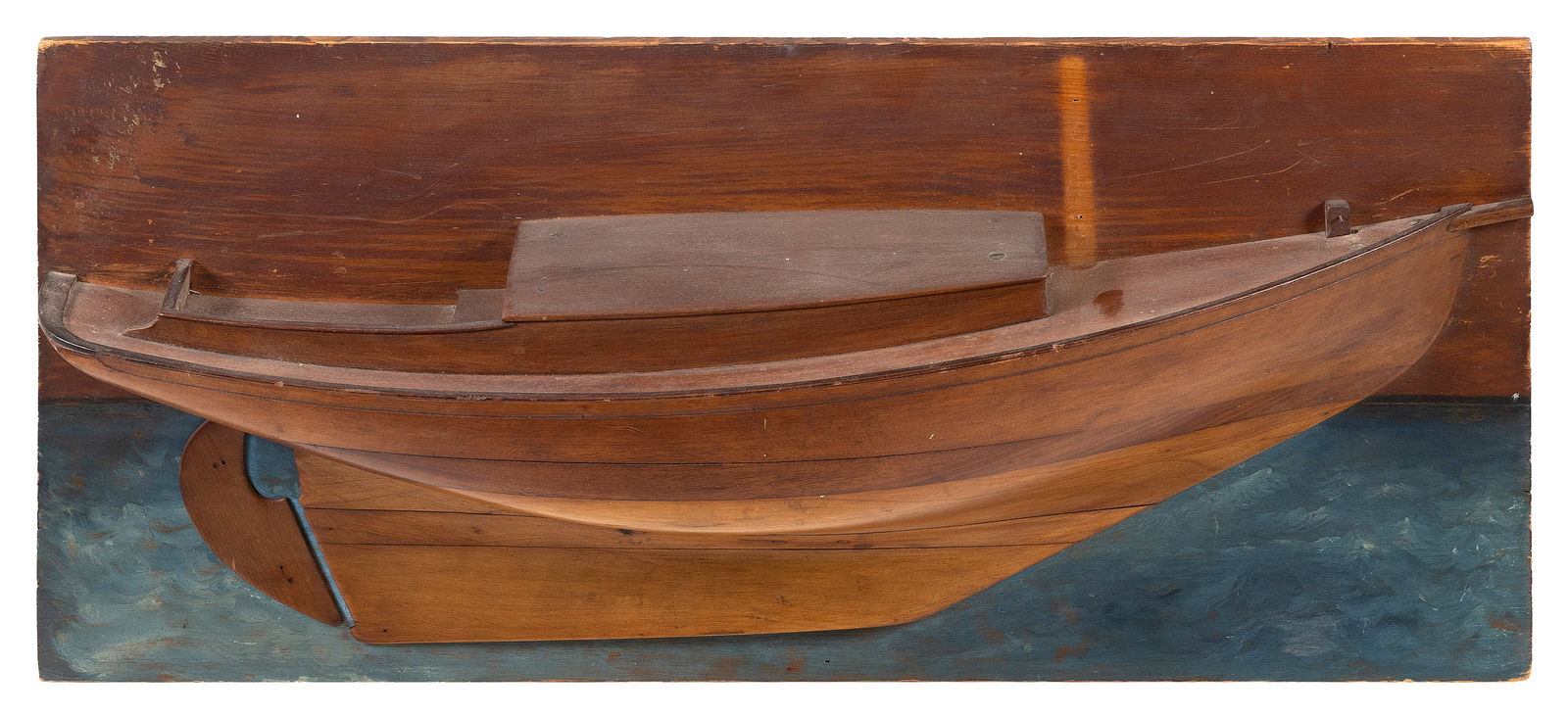 MOUNTED HALF HULL MODEL OF A SLOOP Early 20th Century Pine backboard 14.25" x 31".: MOUNTED HALF HULL MODEL OF A SLOOPEarly 20th CenturyBuilt up in seven lifts.Pine backboard 14.25" x 31".