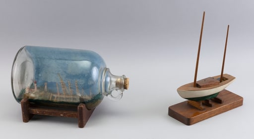 SHIP IN A BOTTLE AND A MODEL OF A TWO-MASTED SAILING VESSEL 20th Century Bottle height 6.5". Length