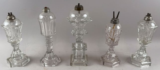 FIVE CLEAR SANDWICH GLASS WHALE OIL LAMPS Mid-19th Century Heights including burners from 10" to