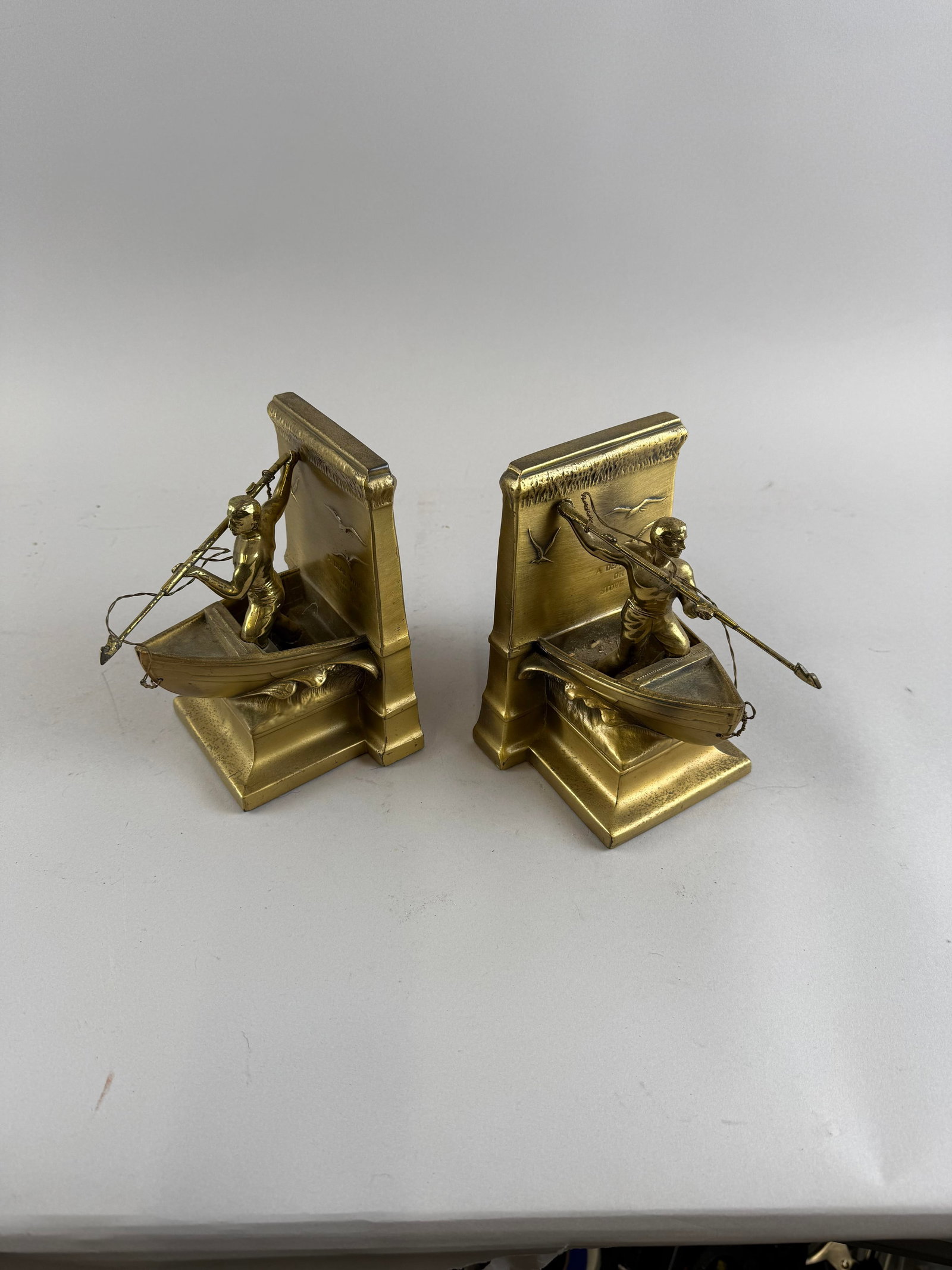 PAIR OF BRASS NEW BEDFORD WHALEMAN BOOKENDS Circa 1950 Heights 7".: PAIR OF BRASS NEW BEDFORD WHALEMAN BOOKENDS Circa 1950 Formed as a harpooner poised at the bow of a whaleboat. Heights 7".