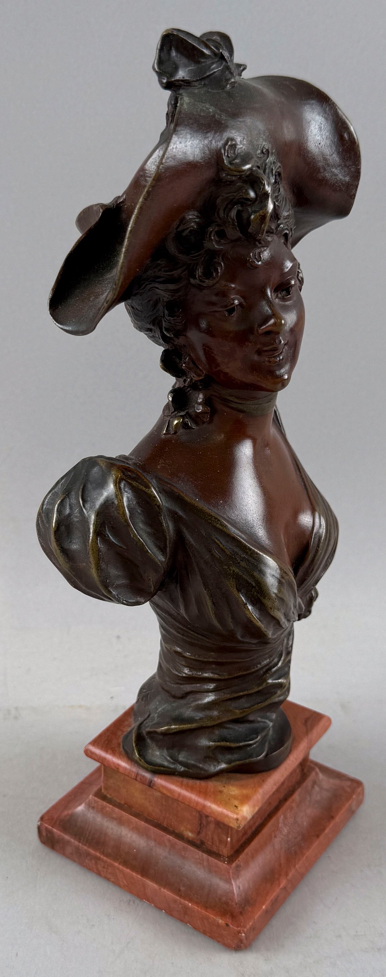MARCEL DEBUT (France, 1865-1933), Bust of a lady., Bronze on a rouge marble base, height 10.25".: MARCEL DEBUT France, 1865-1933 Bust of a lady. Marked for Tiffany & Co. near the artist's signature. Bronze on a rouge marble base, height 10.25". Base 3.25" x 3.375".