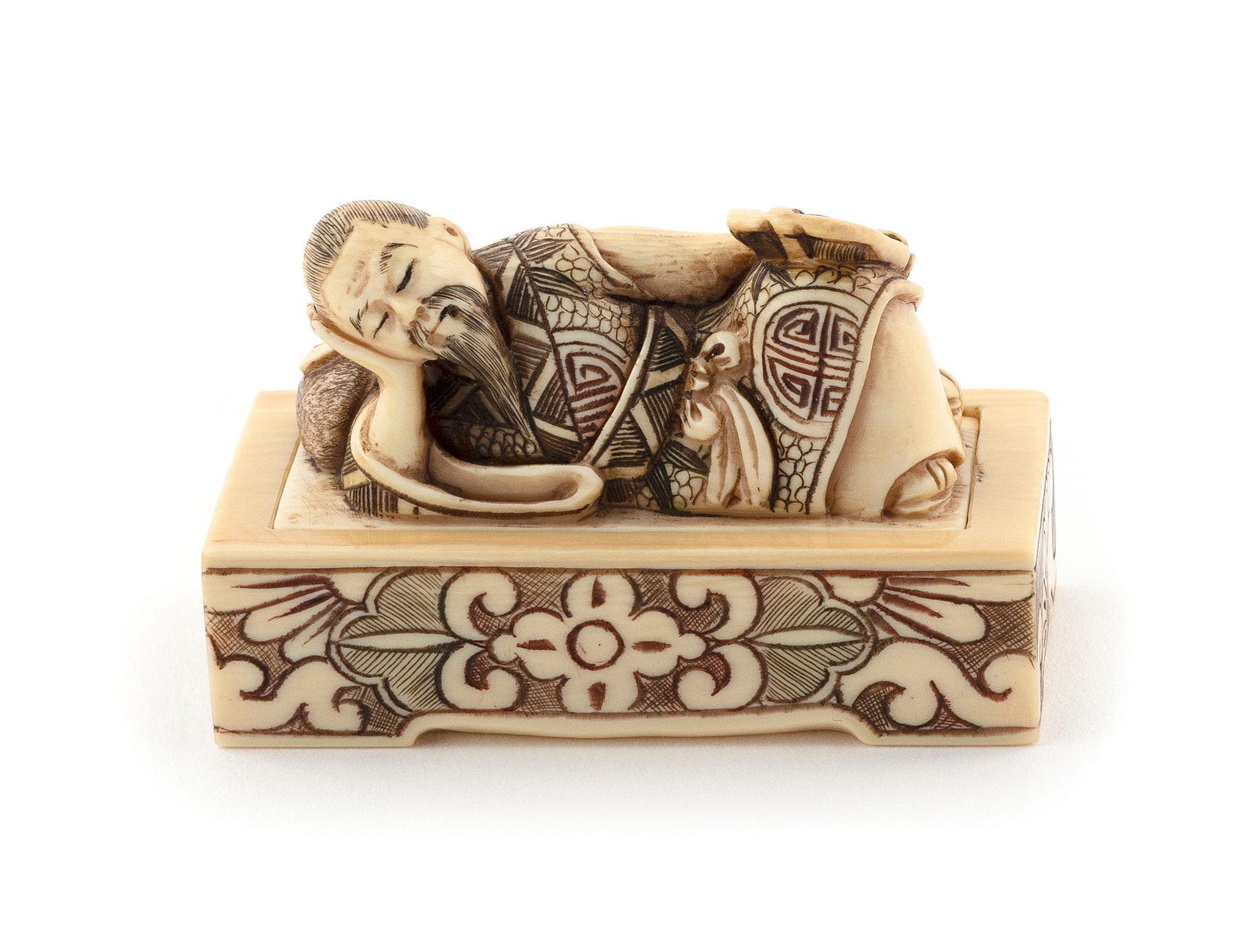 JAPANESE CARVED IVORY TWO-PIECE SHUNGA OKIMONO BY GYOKUSHO Late 19th Century Length 2".: JAPANESE CARVED IVORY TWO-PIECE SHUNGA OKIMONO BY GYOKUSHOLate 19th CenturyA sleeping man and his erotic dream. The upper piece with a courtesan resting with his head on one hand and a fan in his othe