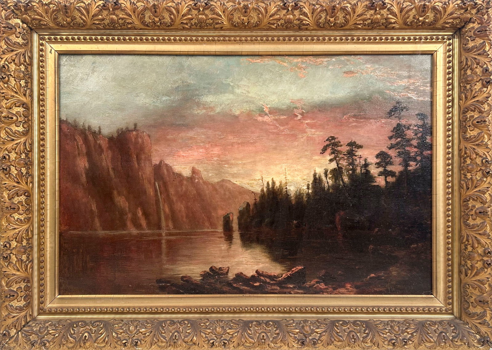 AMERICAN SCHOOL (19th Century,), Sunset over a cliff-lined river., Oil on canvas, 16" x 25". Framed: AMERICAN SCHOOL 19th Century Sunset over a cliff-lined river. Signed faintly and illegibly lower right. Oil on canvas, 16" x 25". Framed 22.5" x 32".