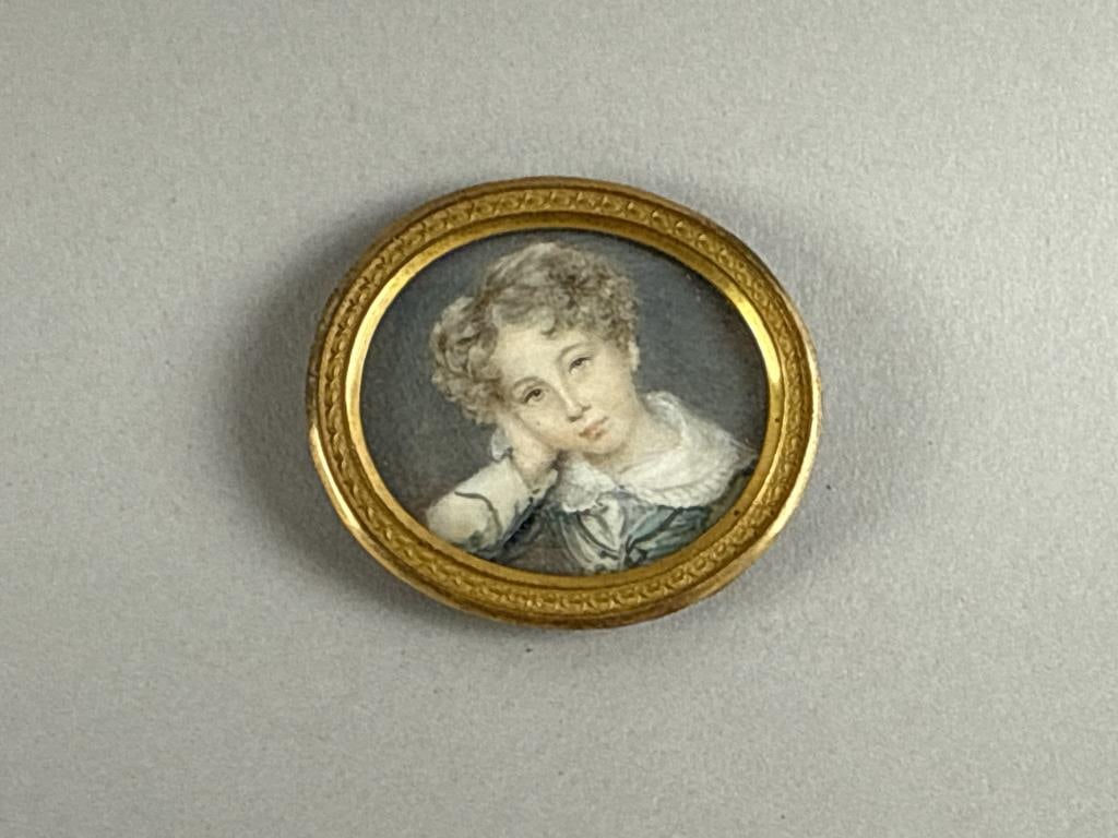 PORTRAIT MINIATURE OF A YOUNG BOY England, Early to Mid-19th Century 1.75" x 2".: PORTRAIT MINIATURE OF A YOUNG BOY England, Early to Mid-19th Century Unusual depiction of a boy resting his head on his hand. Handwritten history of the Hope family on reverse. Likely painted on ivory