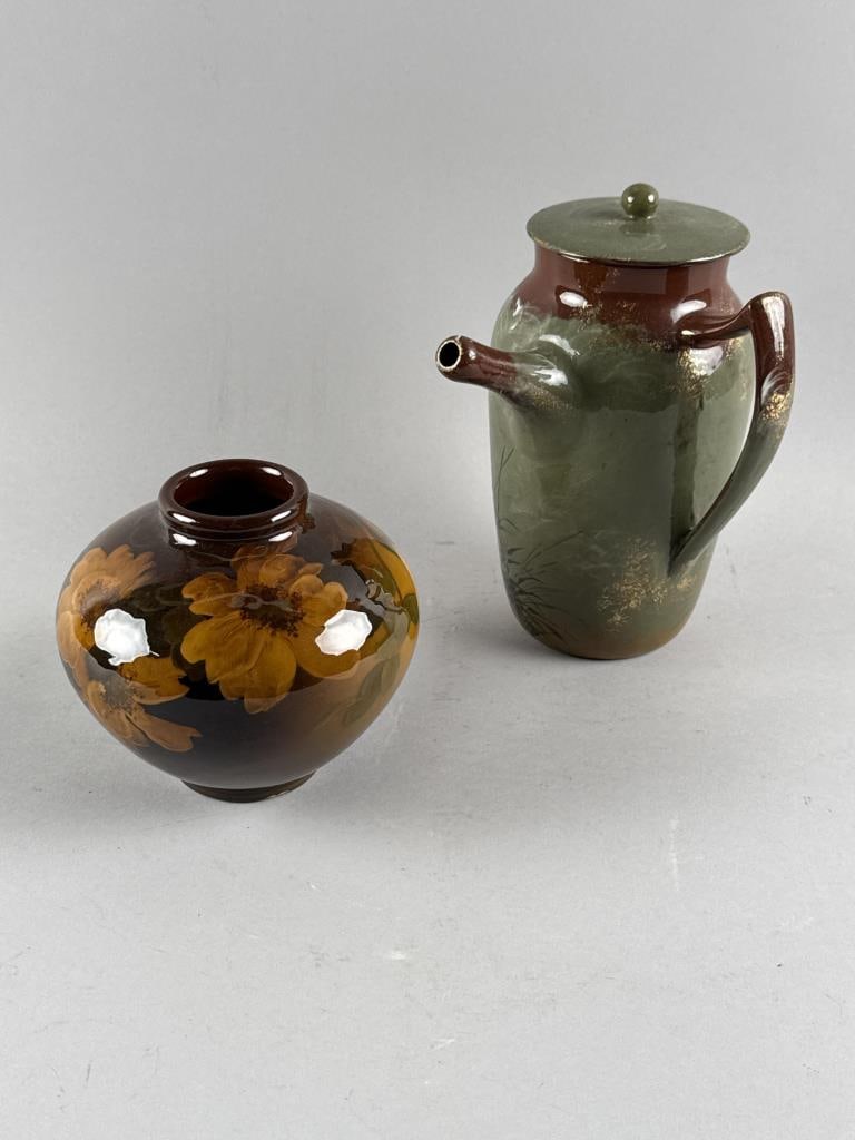 LENA E. HANSCOM FOR ROOKWOOD SQUAT VASE TOGETHER WITH A COVERED CHOCOLATE POT Cincinnati, Early 19th: LENA E. HANSCOM FOR ROOKWOOD SQUAT VASE TOGETHER WITH A COVERED CHOCOLATE POT Cincinnati, Early 19th Century Vase with floral decoration against a brown ground. Signed "LEH" and marked for Rookwood on