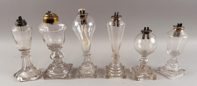 SIX CLEAR GLASS WHALE OIL LAMPS First Half of the 19th Century Heights from 7" to 8.5".