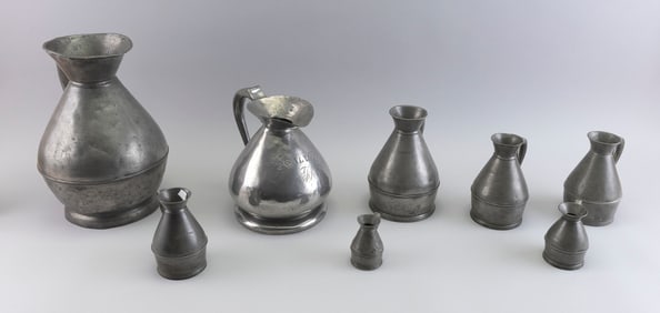ASSEMBLED SET OF EIGHT PEWTER HAYSTACK MEASURES Late 18th/Early 19th Century Heights from 3" to 12".