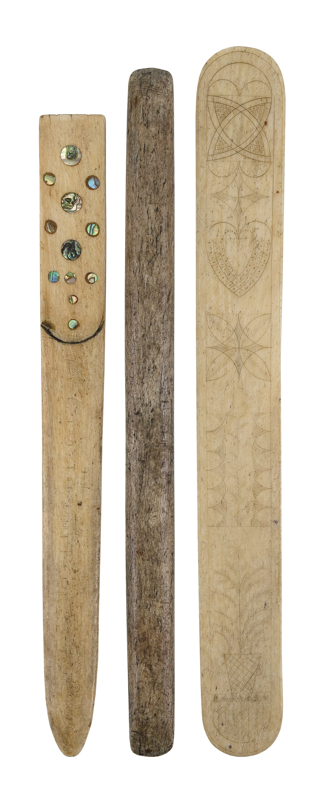 THREE WHALEBONE ITEMS 19th Century Lengths from 11.5" to 12.75".: THREE WHALEBONE ITEMS 19th Century A scrimshaw busk, a seam rubber and a letter opener with mother-of-pearl inlay. Lengths from 11.5" to 12.75".