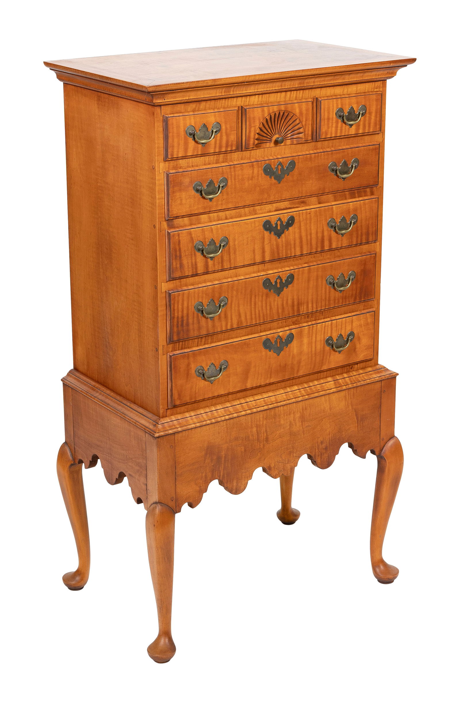 DIMINUTIVE ELDRED WHEELER TIGER MAPLE CHEST-ON-FRAME Massachusetts, 20th Century Height 42.5". Width: DIMINUTIVE ELDRED WHEELER TIGER MAPLE CHEST-ON-FRAMEMassachusetts, 20th CenturyFive full-width drawers, the top drawer simulating three, with a central fan carving. Frame with shaped apron and cabriol