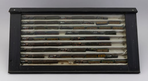 CASED COLLECTION OF CARVED AND PAINTED WOODEN MINIATURE TRAINS Late 19th or Early 20th Century Train