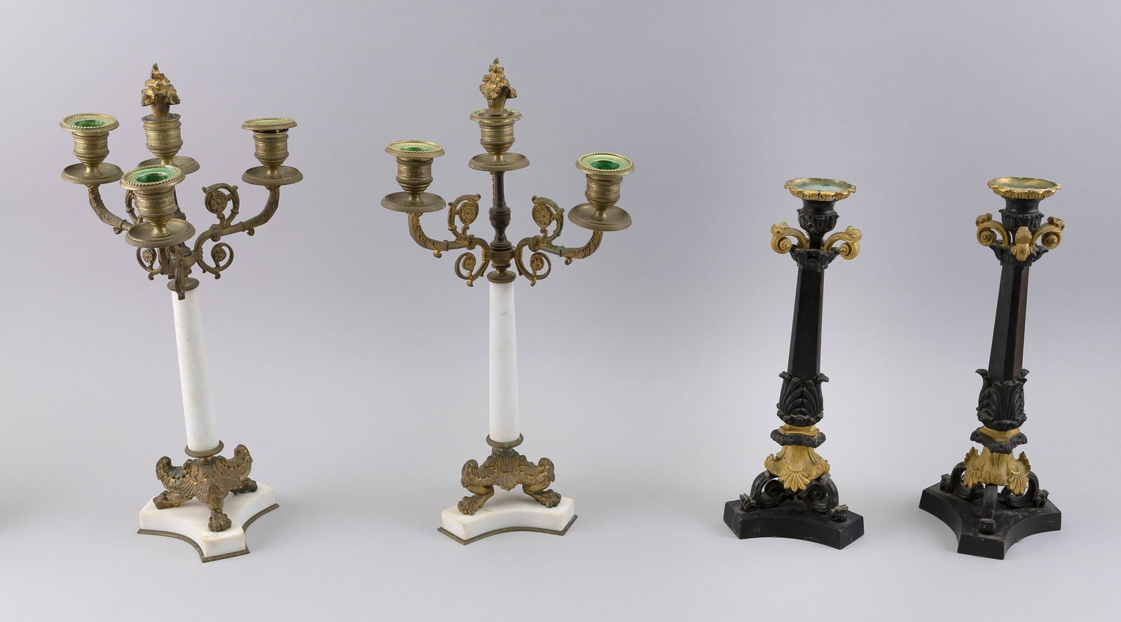 TWO PAIRS OF FRENCH EMPIRE BRONZE AND MARBLE CANDLESTICKS Early to Mid-19th Century Heights 12.5": TWO PAIRS OF FRENCH EMPIRE BRONZE AND MARBLE CANDLESTICKSEarly to Mid-19th CenturyOne pair with ebonized shafts and the other pair with white marble shafts and detachable bobeches.Heights 12.5" and 16