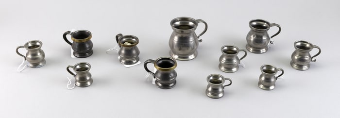 ELEVEN PEWTER MEASURES Late 18th/Early 19th Century Heights from 1.75" to 3.5".