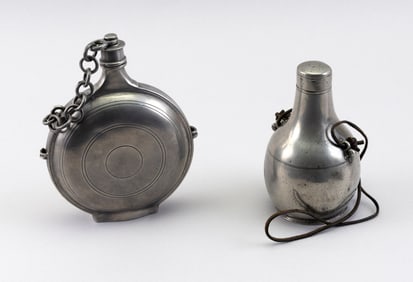 TWO PEWTER FLASKS England and Europe, Late 18th/Early 19th Century Heights 6" and 7.5".