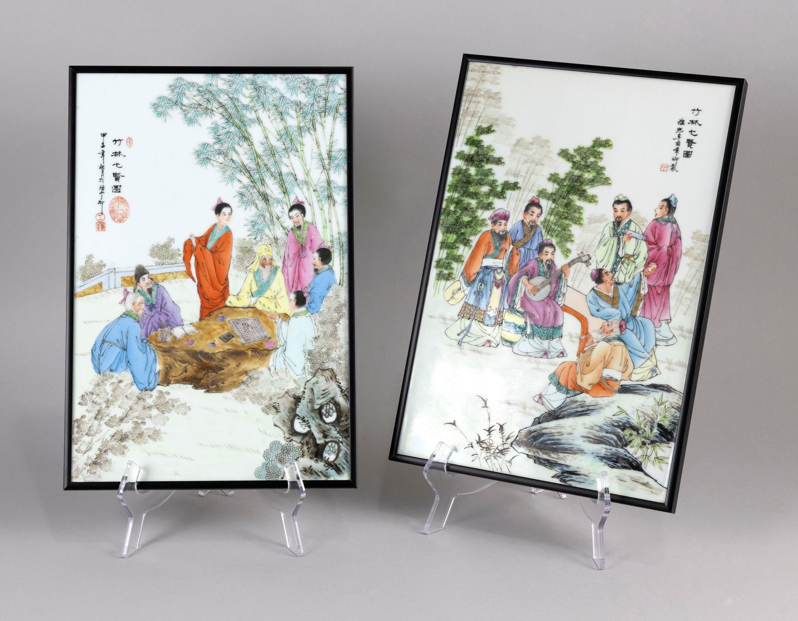 PAIR OF CHINESE FAMILLE ROSE PORCELAIN TILE PAINTINGS Late 19th/Early 20th Century 9" x 14". Framed: PAIR OF CHINESE FAMILLE ROSE PORCELAIN TILE PAINTINGSLate 19th/Early 20th CenturyOne depicts figures playing Go in a courtyard and the other with figures listening to music in a landscape. Both with r