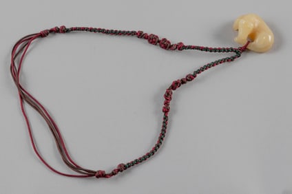 CHINESE WHITE JADE RECLINING HORSE PENDANT Length 1.5".