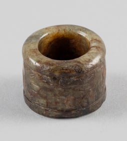 CHINESE MOTTLED GREEN AND BROWN JADE THUMB RING Diameter 1.25".