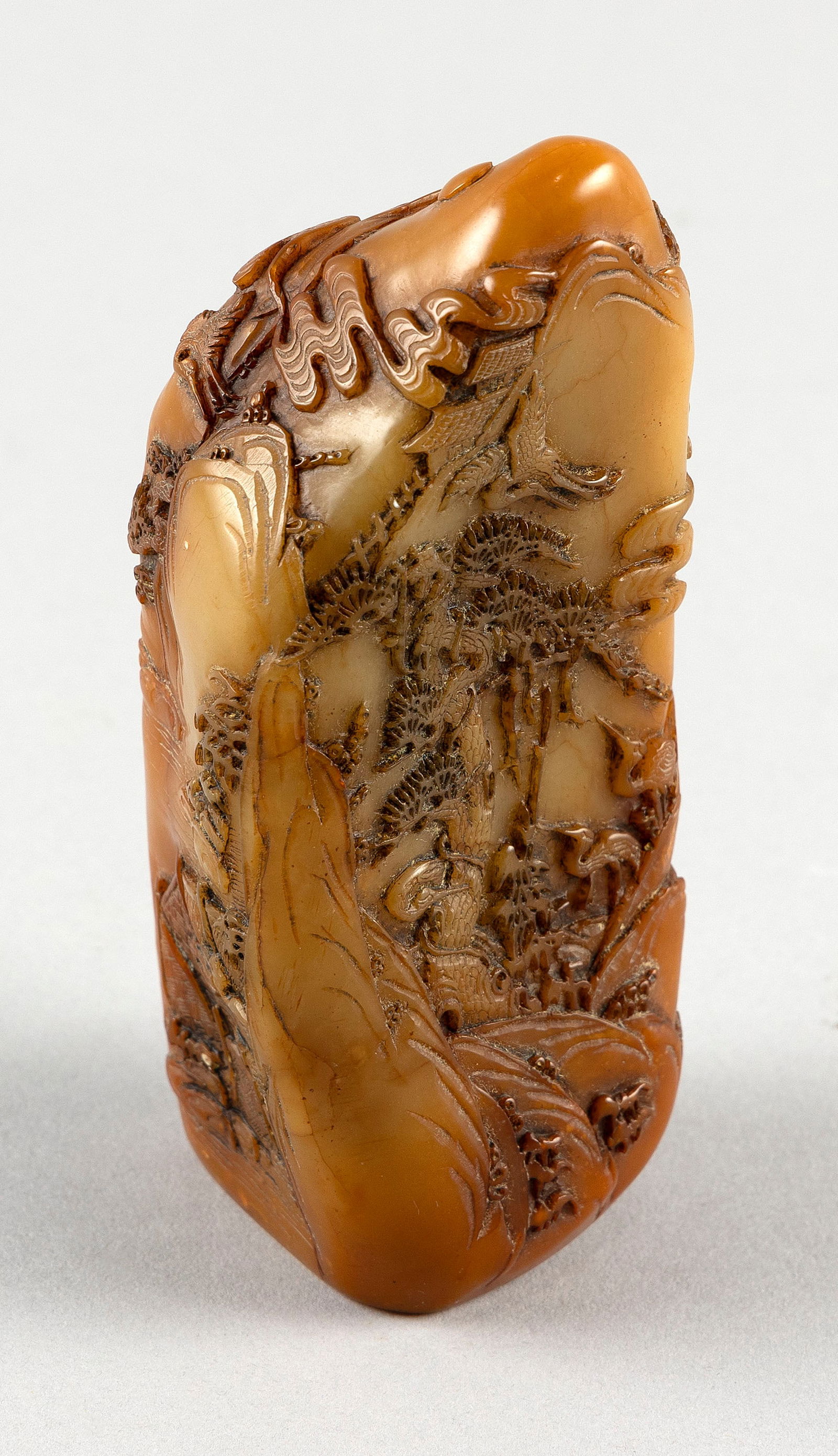 CHINESE CARVED SHOUSHAN STONE PEBBLE 19th Century Height 5".: CHINESE CARVED SHOUSHAN STONE PEBBLE19th CenturyDetailed depiction of cranes, a boat and pine trees in a river landscape.Height 5".