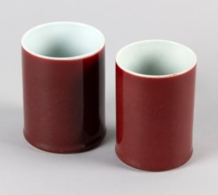 TWO CHINESE NEAR-MATCHING SANG DE BOEUF PORCELAIN BRUSH POTS Late 19th/Early 20th Century Heights