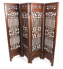 CHINESE CARVED WOOD FOUR-PANEL FOLDING SCREEN Late 19th/Early 20th Century Each panel 69.5" x 17.5".
