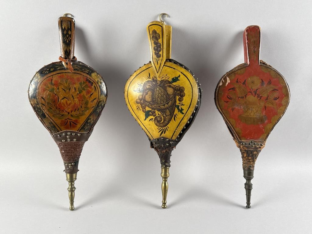THREE PAINT-DECORATED BELLOWS 19TH Century Lengths 18". Widths 7.5". Depths 2.75".: THREE PAINT-DECORATED BELLOWS19TH CenturyOne with a cornucopia, one with a floral and foliate design and one with a vase of flowers.Lengths 18". Widths 7.5". Depths 2.75".