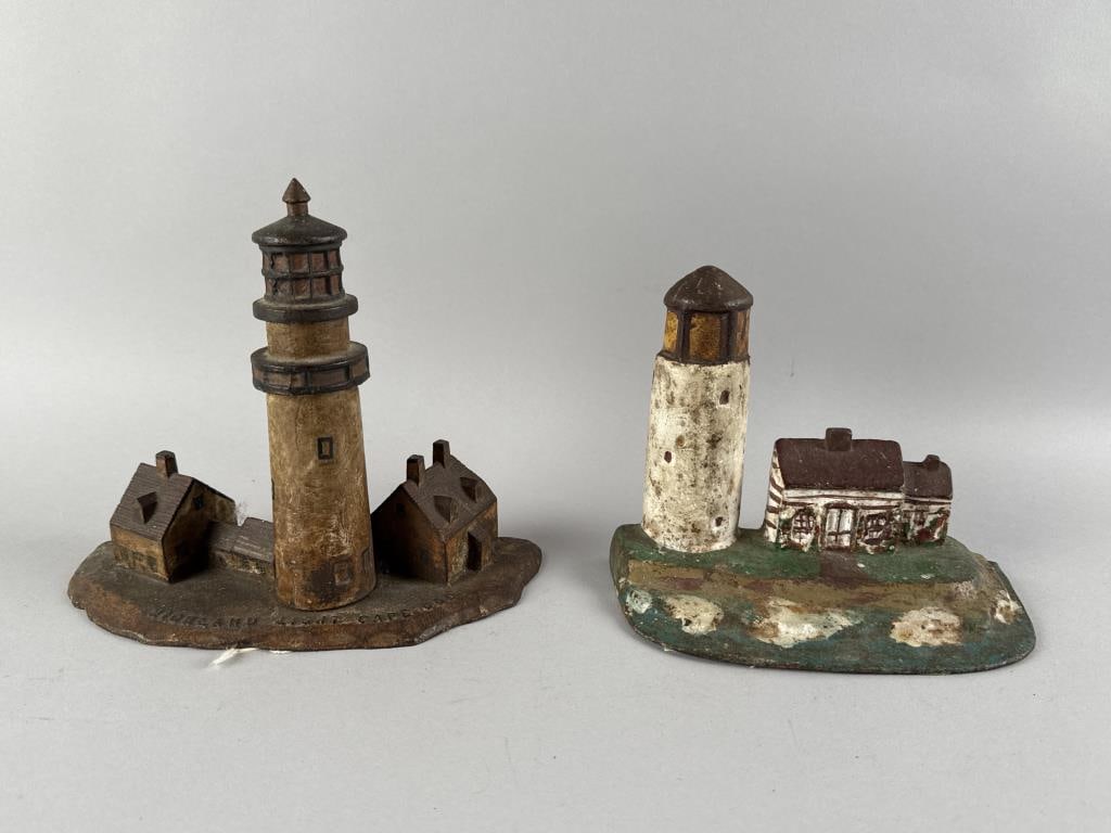 TWO CAST IRON LIGHTHOUSE DOORSTOPS Early 20th Century Heights 7" and 8".: TWO CAST IRON LIGHTHOUSE DOORSTOPSEarly 20th CenturyOne of Highland Light, located in Truro, Massachusetts.Heights 7" and 8".