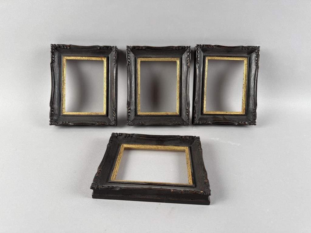 SET OF FOUR EXPORT PICTURE FRAMES Heights 6.25". Widths 7.75". Depths 1".: SET OF FOUR EXPORT PICTURE FRAMESCarved and dark stained wood frames with gilt lips.Heights 6.25". Widths 7.75". Depths 1".