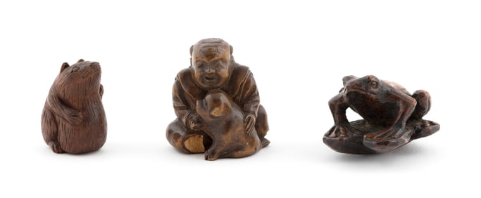 THREE JAPANESE CARVED WOOD NETSUKE Late 19th/Early 20th Century Heights from 1.25" to 1.625".