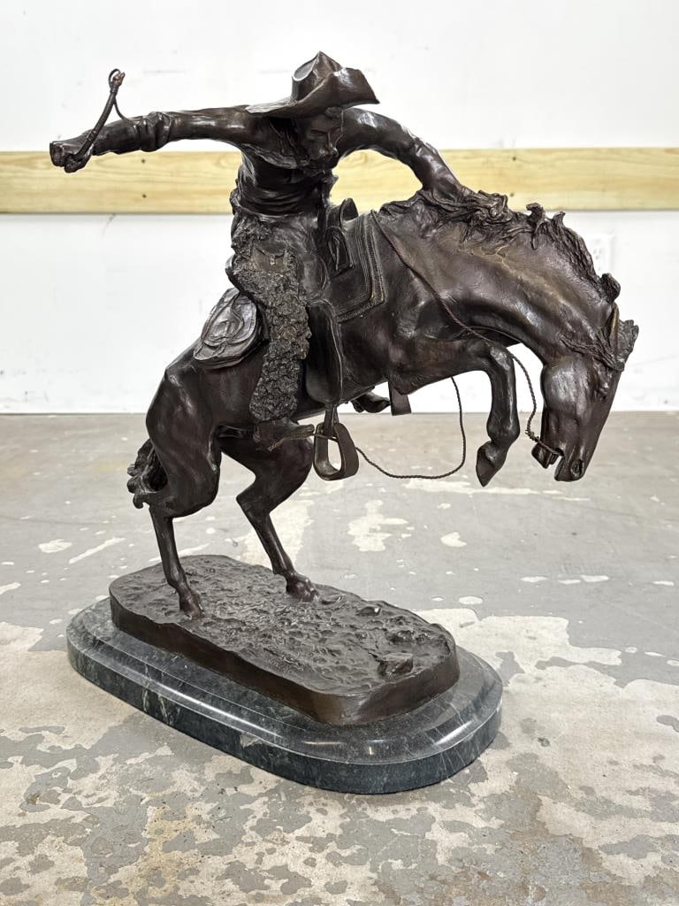 AFTER FREDERICK REMINGTON (20th Century,), "The Bronco Buster"., Bronze on a green marble base,: AFTER FREDERICK REMINGTON20th Century"The Bronco Buster". Bronze on a green marble base, total height 20".
