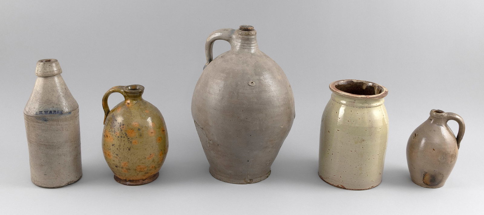 FIVE PIECES OF EARTHENWARE 19th/20th Century Heights from 7" to 13".: FIVE PIECES OF EARTHENWARE19th/20th CenturyTwo stoneware jugs, a stoneware beer bottle, a redware jug and a crock.Heights from 7" to 13".