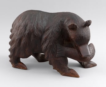 CARVED WOODEN BEAR WITH A FISH IN ITS MOUTH 20th Century Height 10". Length 17".