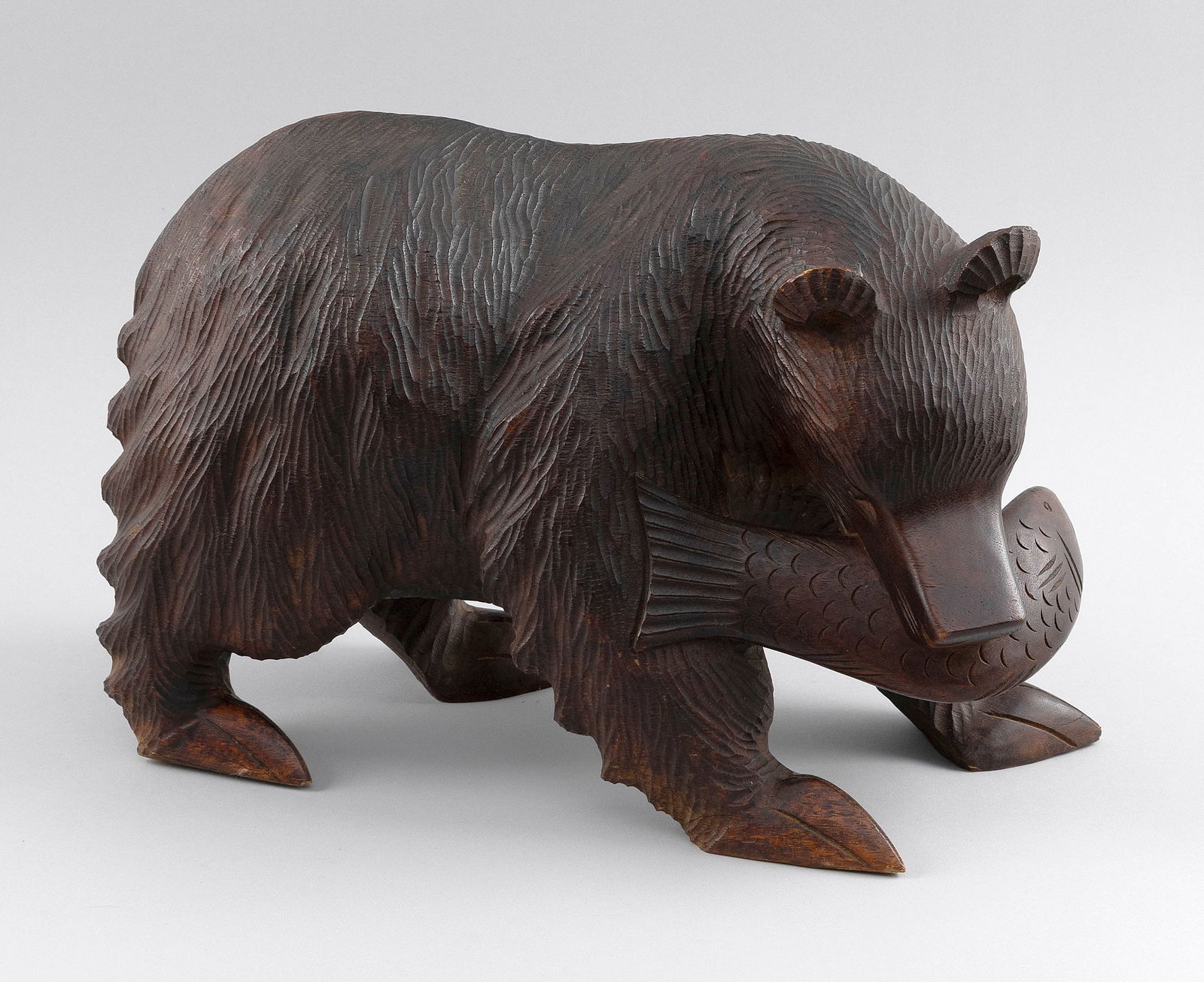 CARVED WOODEN BEAR WITH A FISH IN ITS MOUTH 20th Century Height 10". Length 17".: CARVED WOODEN BEAR WITH A FISH IN ITS MOUTH20th CenturyUnsigned.Height 10". Length 17".