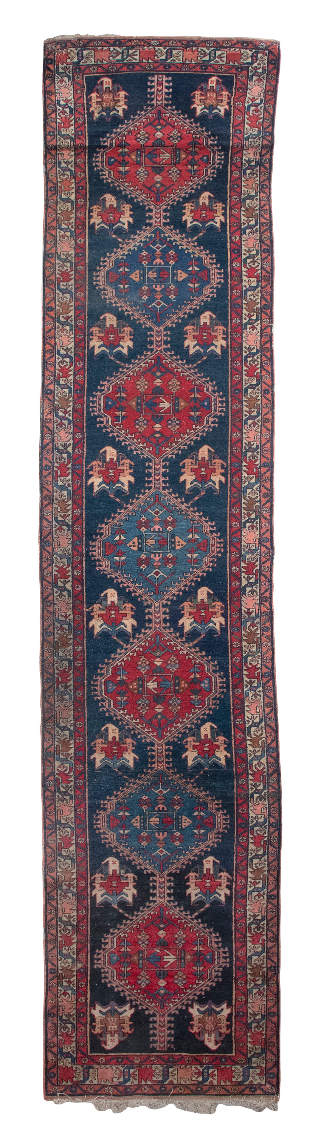 NORTHWEST PERSIAN DESIGN RUNNER: 2'11" X 13'10" Late 20th Century: NORTHWEST PERSIAN DESIGN RUNNER: 2'11" X 13'10"Late 20th CenturyA linked strand of red and blue geometric medallions run the length of a navy blue field. Medallions contain and are flanked by typical