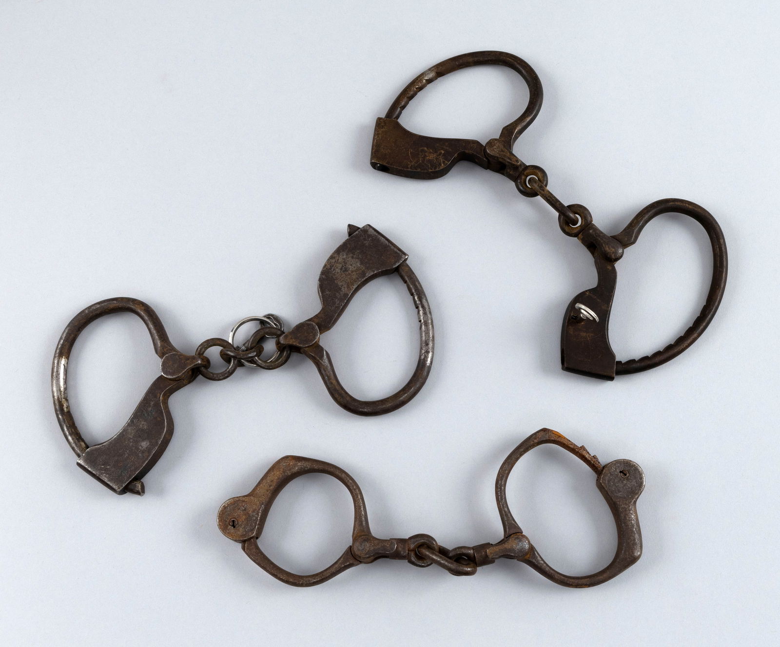 THREE PAIRS OF POLICE HANDCUFFS 19th Century Lengths 9". (1 of 2)