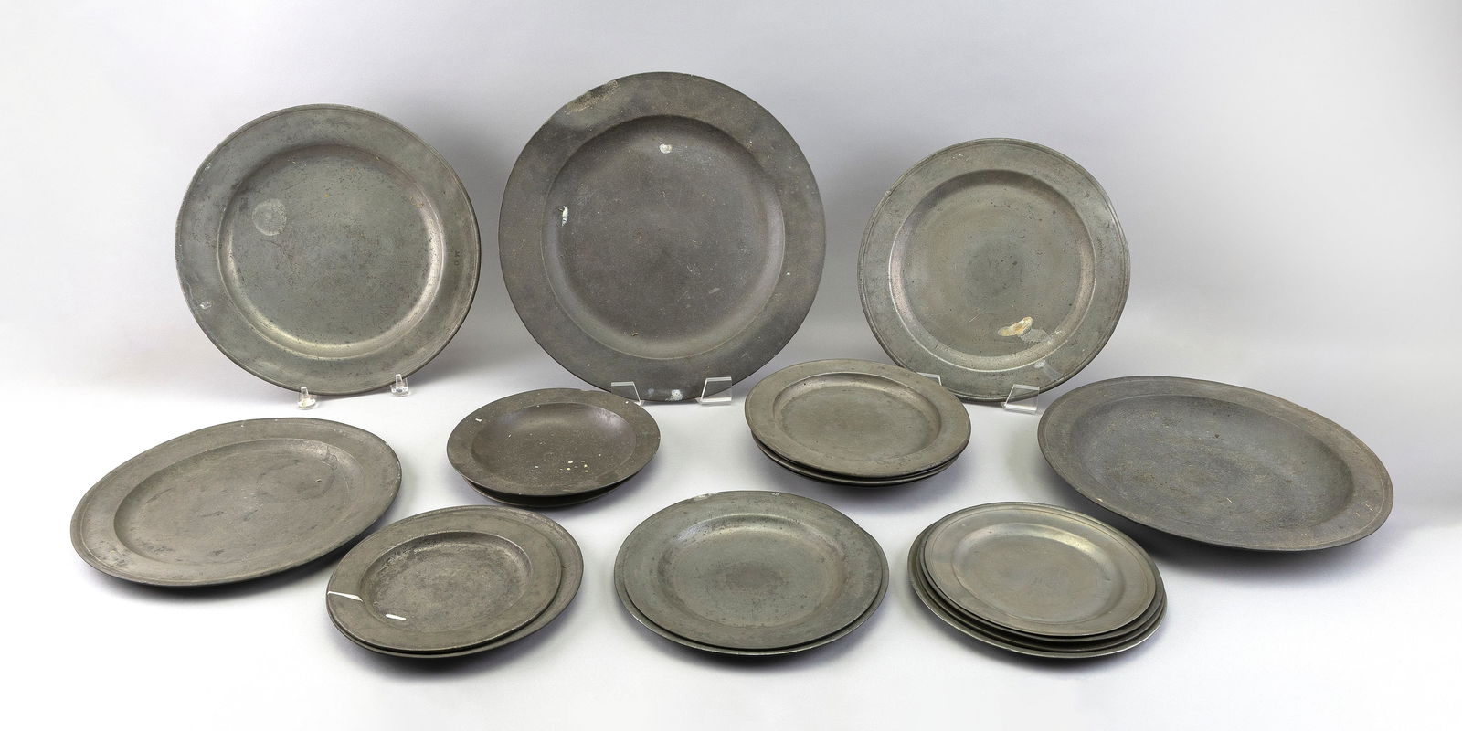 NINETEEN PEWTER PLATES AND CHARGERS 18th-20th Century Diameters from 8" to 16.75". (1 of 1)