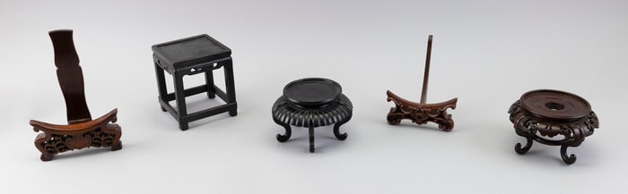FIVE CHINESE CARVED WOOD STANDS Early 20th Century Heights from 4" to 8".