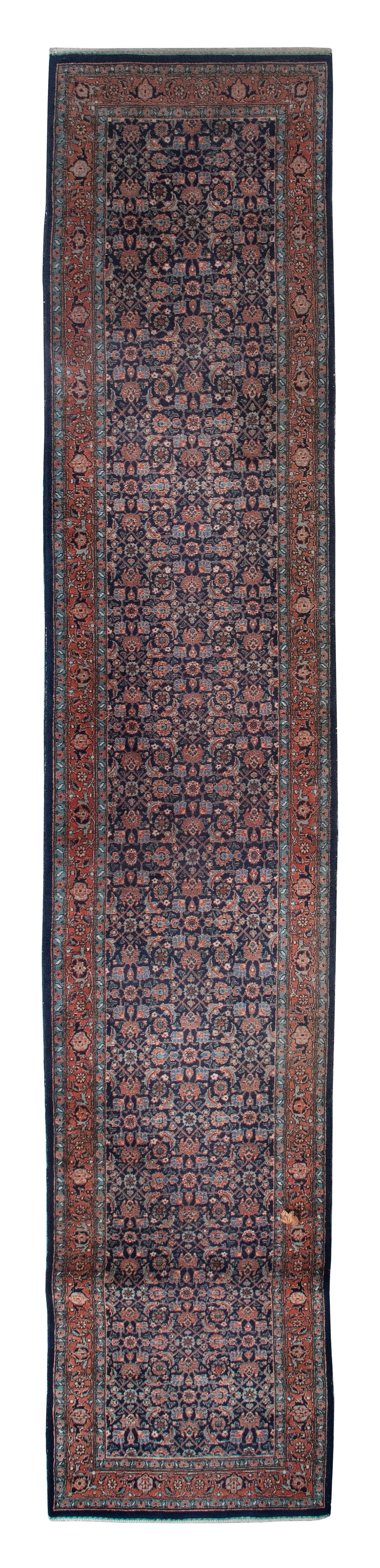 PERSIAN BIDJAR RUG: 2'9" X 13'10", Second Quarter of the 20th Century: PERSIAN BIDJAR RUG: 2'9" X 13'10"Second Quarter of the 20th CenturyRed, blue and green Herati pattern on a dark blue field. Aqua and tomato red borders.