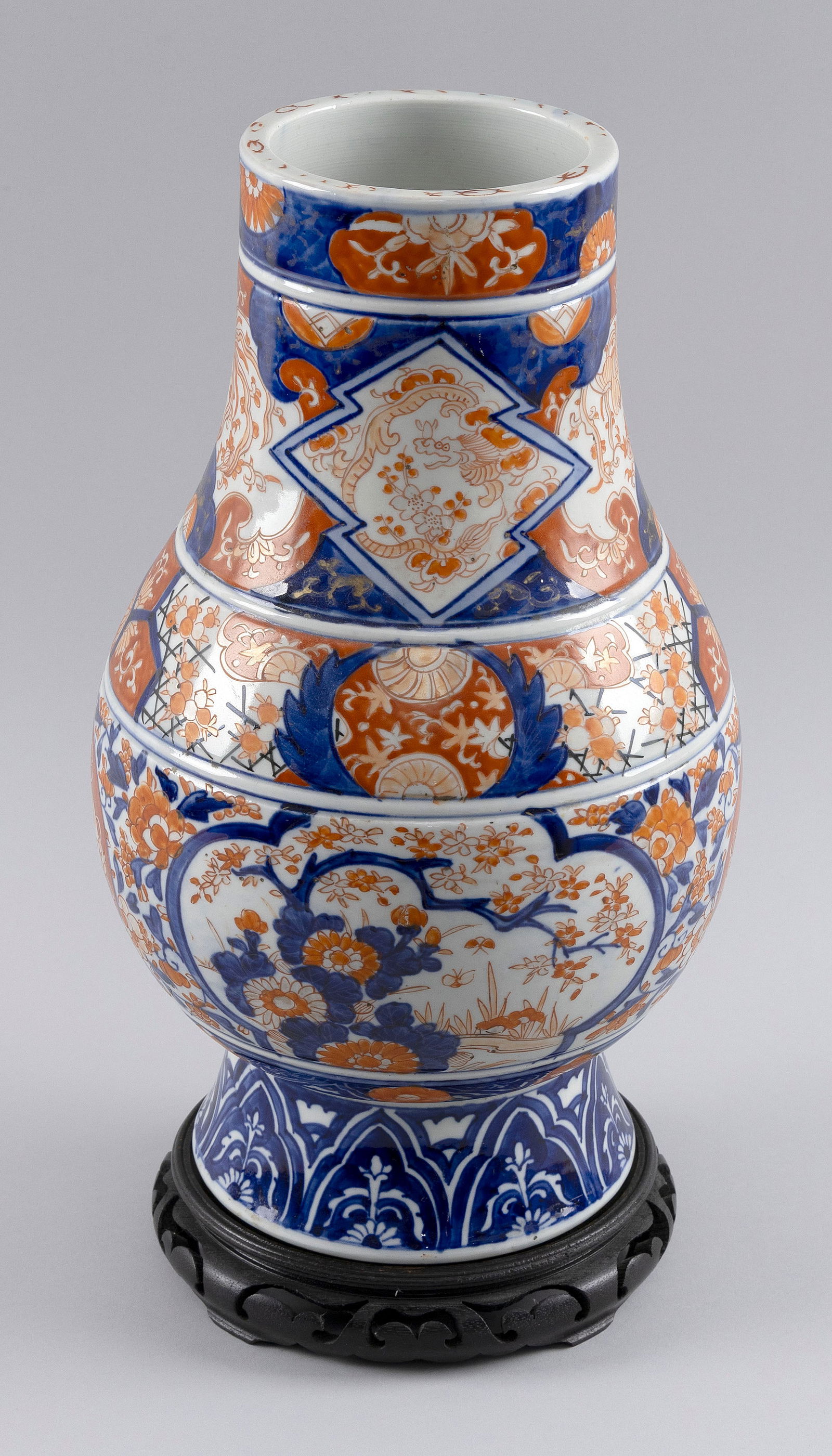 JAPANESE FUKAGAWA IMARI VASE Late 19th Century Height 14.5". With wooden base.: JAPANESE FUKAGAWA IMARI VASELate 19th CenturyHeight 14.5". With wooden base.