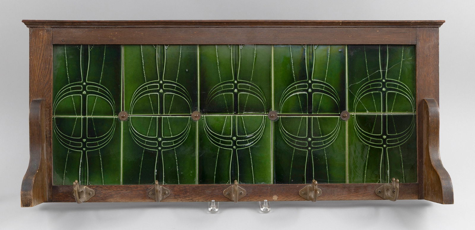 ARTS AND CRAFTS COAT RACK Early 20th Century Height 15". Width 33".: ARTS AND CRAFTS COAT RACKEarly 20th CenturyWood frame with ten green porcelain tiles and metal hooks.Height 15". Width 33".