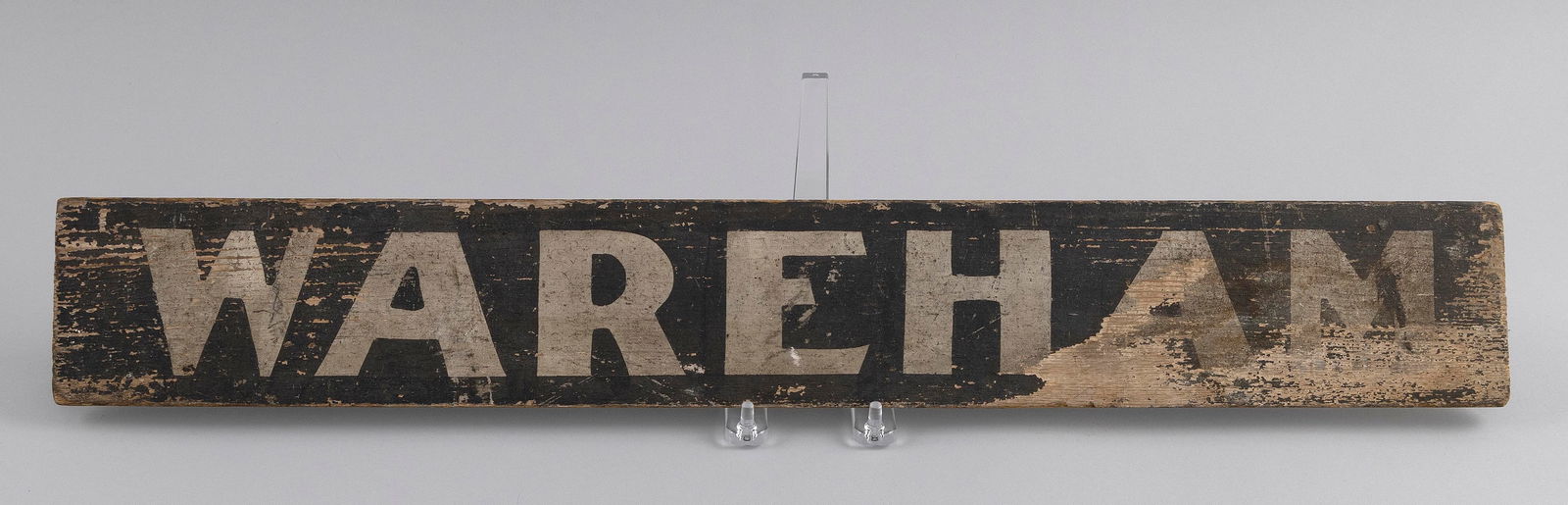 WAREHAM TROLLEY STOP DOUBLE-SIDED SIGN Early 20th Century 3.75" x 25".: WAREHAM TROLLEY STOP DOUBLE-SIDED SIGNEarly 20th CenturyPine board with "Wareham" and "Special" in white painted lettering against a black ground.3.75" x 25". Notes:From about 1901 to 1927 an elect
