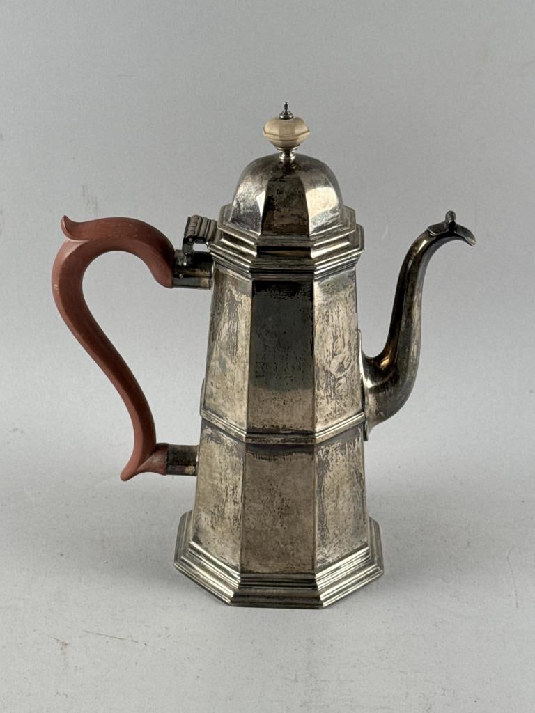 ELIZABETH II STERLING SILVER COFFEEPOT London, 20th Century Approx. 38.6 troy oz. inclusive of wood: ELIZABETH II STERLING SILVER COFFEEPOTLondon, 20th CenturyRetailer's mark "SC&LCo" for Shreve, Crump & Low. Date letter for 1959. Paneled lighthouse form. Presentation inscription on underside. Height