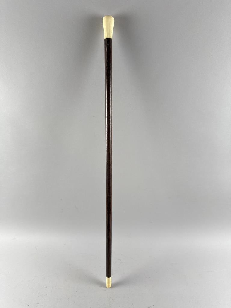 CANE WITH WALRUS IVORY HANDLE 19th Century Length 33.5".: CANE WITH WALRUS IVORY HANDLE 19th Century Wood shaft with bone ferrule. Length 33.5".