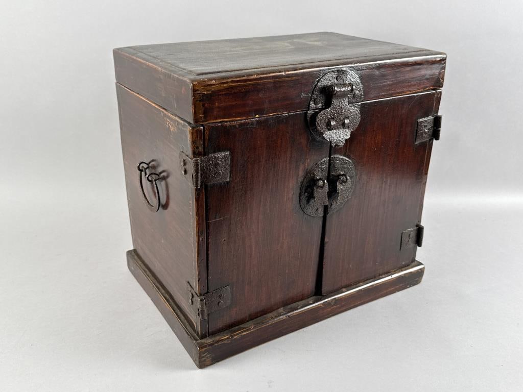 SMALL ASIAN CHEST 19th Century Height 14.25". Width 15.5". Depth 10.75".: SMALL ASIAN CHEST19th CenturyTop hinges open. Two doors at front conceal an interior drawer. Bold hammered metal hardware.Height 14.25". Width 15.5". Depth 10.75".