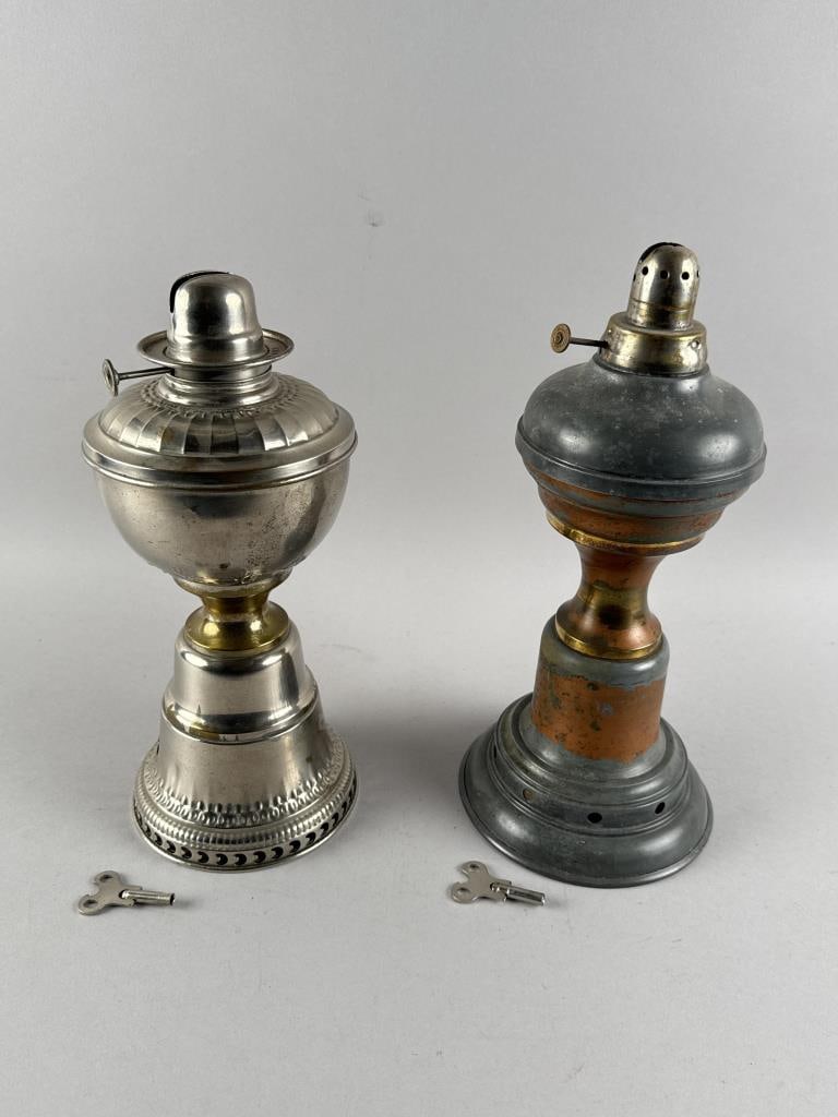 TWO TIME LAMPS WITH CLOCKWORK MECHANISMS Late 19th/Early 20th Century Heights 12" and 12.75". (1 of 3)