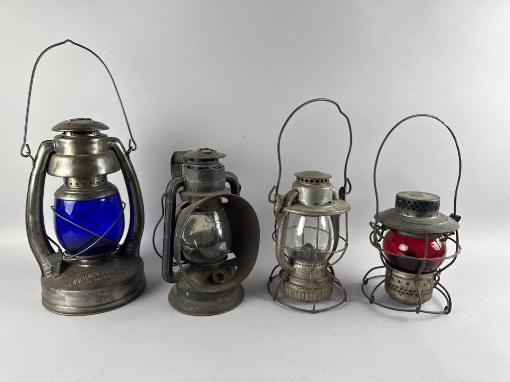 FOUR RAILROAD LANTERNS Late 19th/Early 20th Century Heights from 9.75" to 14".: FOUR RAILROAD LANTERNSLate 19th/Early 20th CenturyMakers include Dietz and Embury. One with a red globe, one a blue globe and two with clear globes.Heights from 9.75" to 14".