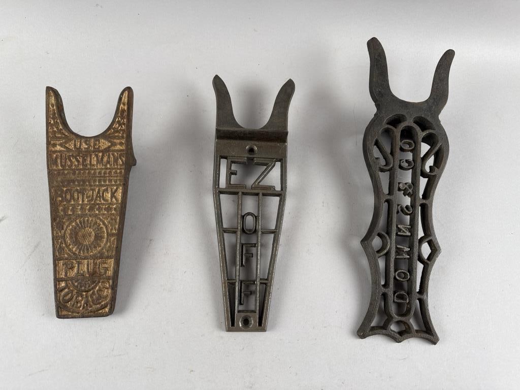 THREE CAST IRON ADVERTISING BOOTJACKS Late 19th/Early 20th Century Lengths from 9.5" to 13.75".: THREE CAST IRON ADVERTISING BOOTJACKSLate 19th/Early 20th CenturyOne for Musselmans plug tobacco, One for EZ Off and one for Downs & Co.Lengths from 9.5" to 13.75".