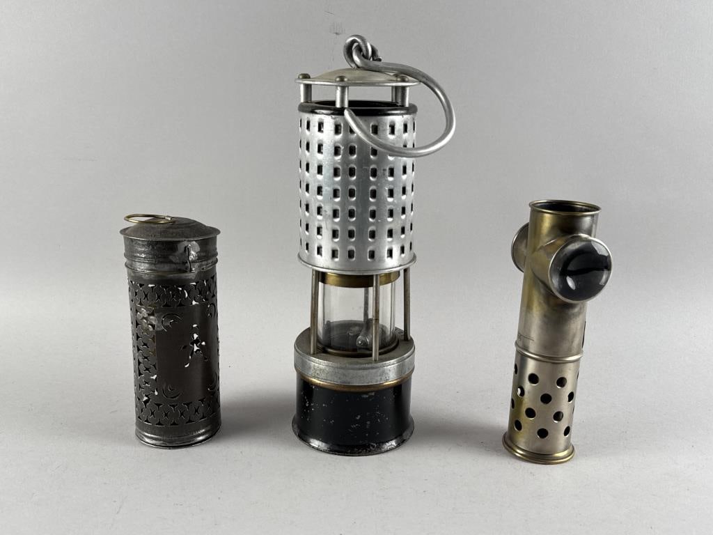 THREE LIGHTING DEVICES Late 19th/Early 20th Century Heights from 6.75" to 11".: THREE LIGHTING DEVICESLate 19th/Early 20th Century1) Pierced tin candle holder. Unmarked. 2) Lantern marked "Koehler Mfg. Co. Marlboro Mass".3) Unit with two magnifying lenses. Marked "F. Fritsch".Hei