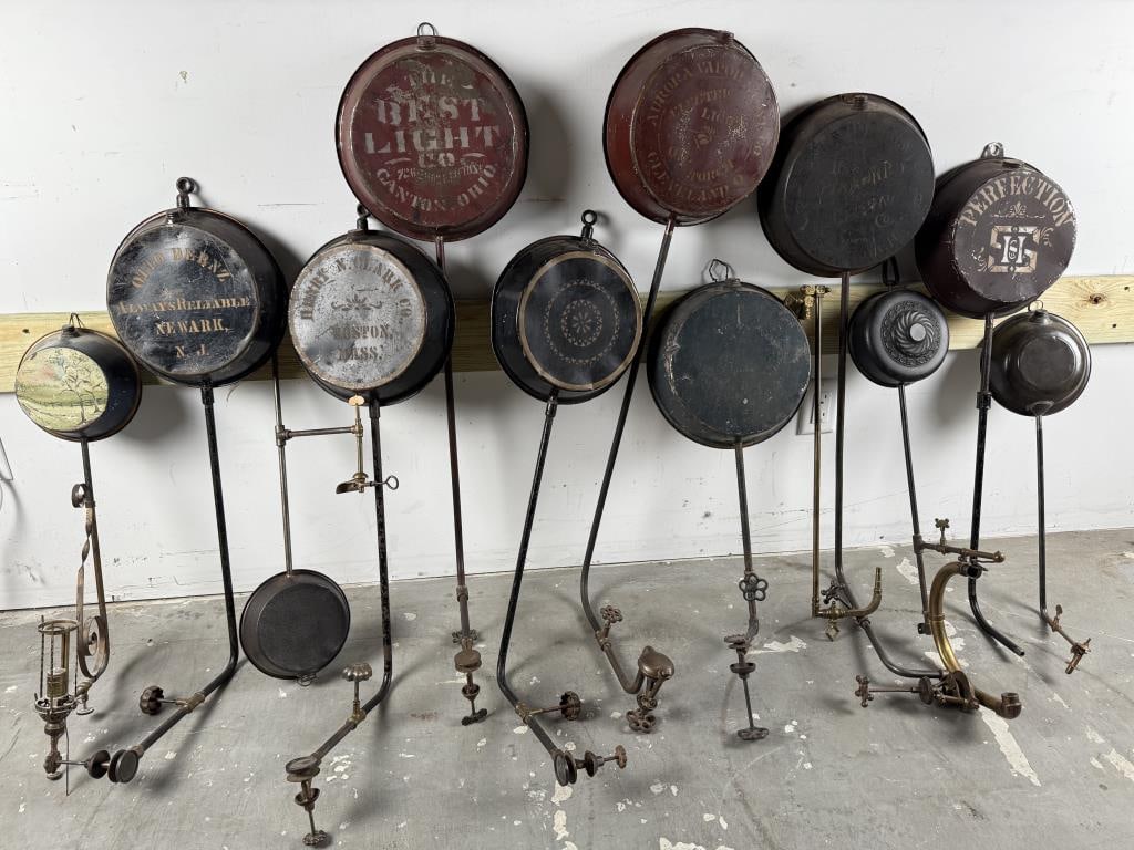 TWELVE TIN FUEL RESERVOIRS FOR LIGHTING DEVICES 19th/Early 20th Century Lengths from 25" to 42.5".: TWELVE TIN FUEL RESERVOIRS FOR LIGHTING DEVICES19th/Early 20th CenturyMarked "The Best Light Co", "Henry N. Clark Co. Boston", "Auto Bernz Newark NJ", "Aurora Vapor Stove Co", etc.Lengths from 25" to